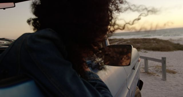 Woman with Curly Hair Relaxing in Car at Sunset Beach - Download Free Stock Images Pikwizard.com
