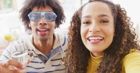 Diverse Couple Celebrating with a Video Call and Drinks