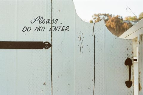 Rustic White Gate With 'Do Not Enter' Sign