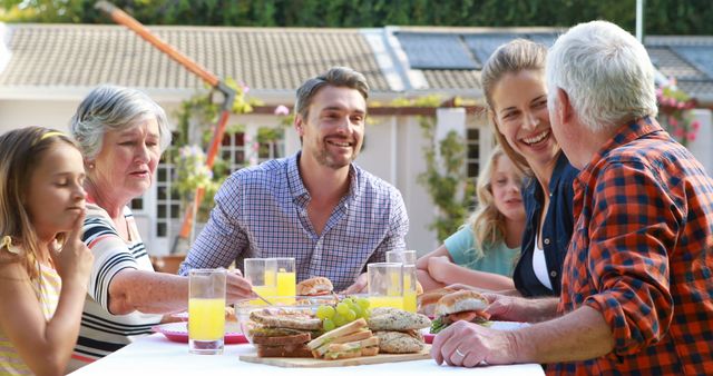 Multigenerational family enjoying meal together outdoors - Download Free Stock Images Pikwizard.com