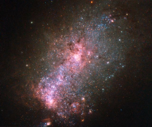 Image features vibrant core of NGC 3125, a starburst galaxy, captured by Hubble Telescope. Displays blue stars and hot gas clouds. Ideal for educational content, astronomy blogs, and science presentations.