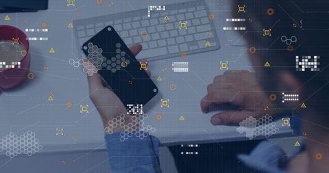 Businessman holding smartphone and typing on keyboard with digital analytics overlay