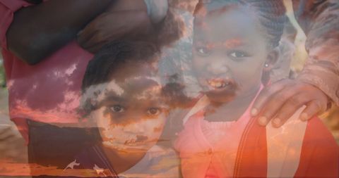Children smiling beneath sunset sky symbolizing love and support