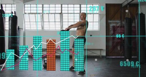 Midadult man swinging kettlebell in industrial gym with analytics overlay