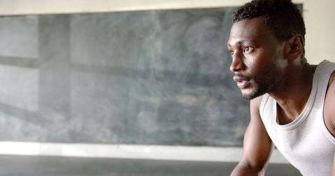 Focused athlete in training studio near blank chalkboard