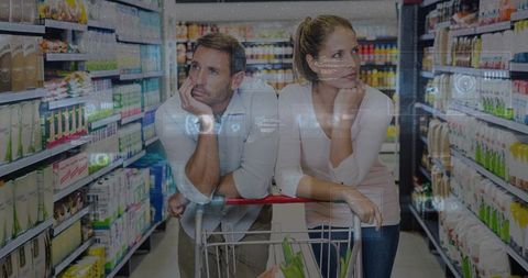 Couple pondering groceries while leaning on shopping cart with augmented reality overlay