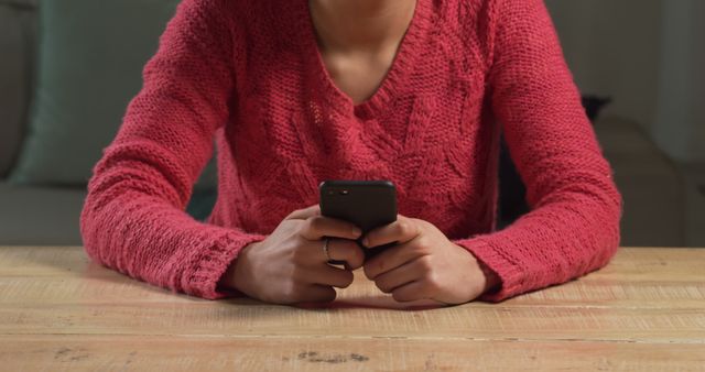 Woman in Red Sweater Using Smartphone at Wooden Table - Download Free Stock Images Pikwizard.com