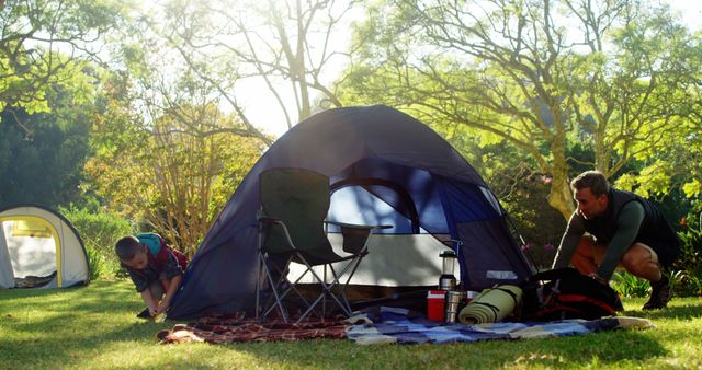 Father and Son Setting Up Camping Tent in Nature Park - Download Free Stock Images Pikwizard.com