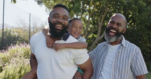Happy Family Bonding Outdoors Piggyback in Sunny Garden