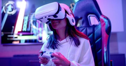 Teenage Girl Engaging in VR Gaming with Headset and Controller