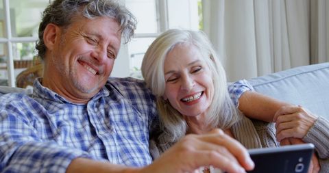 Senior Couple Enjoying Technology at Home