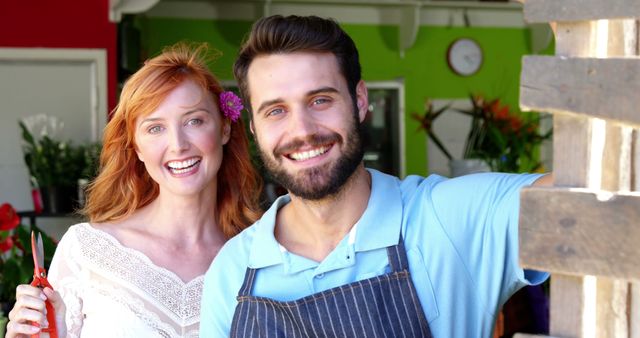 Smiling Florist Couple in Shop with Bright Green and Red Decor - Download Free Stock Images Pikwizard.com