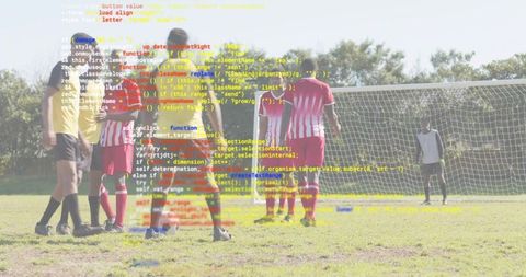 Preparing free kick on grass pitch yellow jersey player placing ball near goal with defensive wall