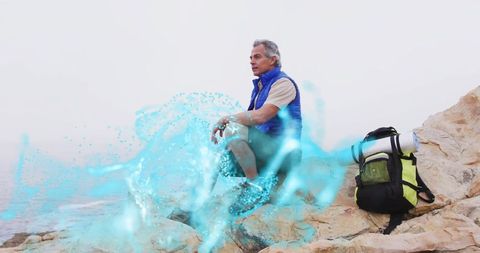 Hiker Overlooking Sea on Rocky Cliff with Ethereal Energy Swirl