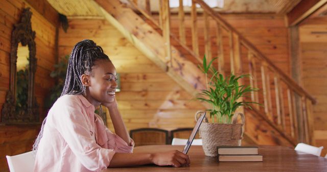 Smiling Woman Using Laptop in Cozy Wooden Home - Download Free Stock Images Pikwizard.com