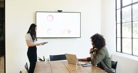 Professional female presentation in modern conference room