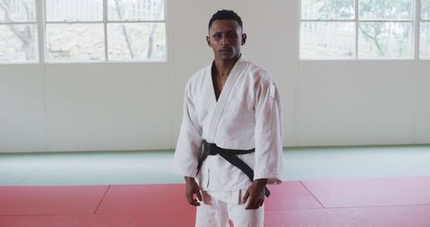 Aspiring Judoka Practicing High Kick in Martial Arts Dojo