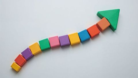 Creative upward curved arrow from colorful blocks for growth concept