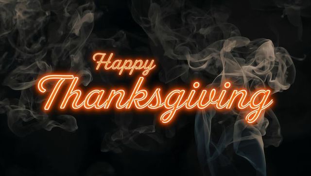 Neon Script Happy Thanksgiving Sign with Orange Glow and Smoky Haze on Dark Background