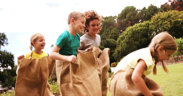 Children Enjoying Fun Sack Race Outdoors on Sunny Day - Download Free Stock Images Pikwizard.com