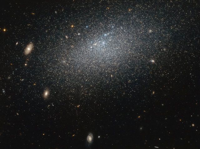 This image shows the irregular dwarf galaxy UGC 4879, an isolated galaxy 2.3 million light years from its closest neighbor, Leo A. The scattered stars of this messy and smaller galaxy demonstrate its solitude and lack of interaction with other galaxies, making it a prime subject for studying star formation without external interference. This photo can be used in educational materials, scientific presentations, or to illustrate articles focused on galaxies, star formation, and cosmic phenomena.