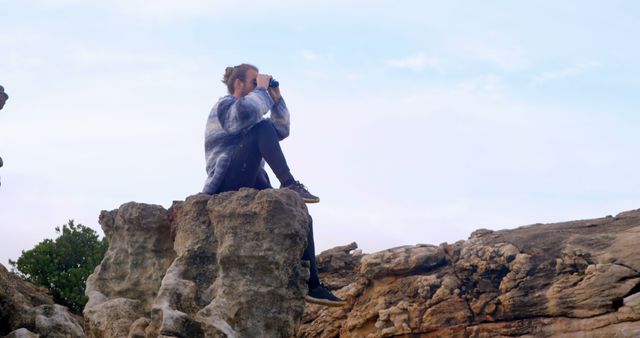 Woman Exploring Rocks with Binoculars in Outdoor Adventure - Download Free Stock Images Pikwizard.com