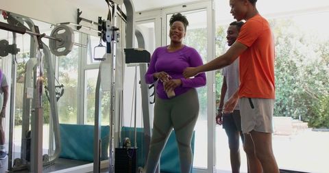 Friends laughing together during home workout session