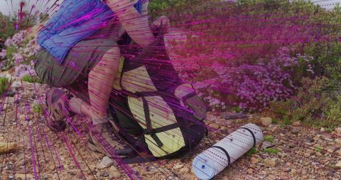 Hiker securing backpack for mountainous adventure