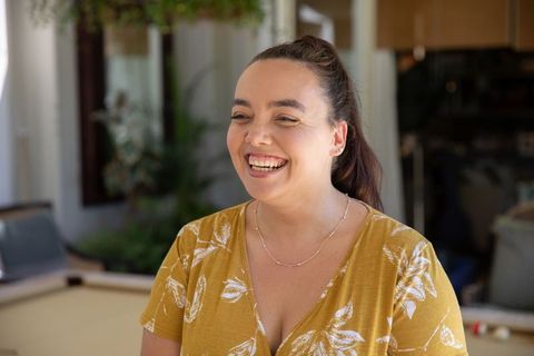 Smiling Woman Enjoying Relaxation in Cozy Home Interior