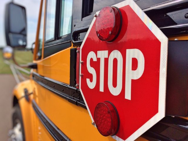 Close-Up of School Bus Stop Sign with Flashing Lights - Download Free Stock Photos Pikwizard.com