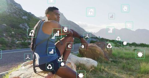 Eco-Conscious Hiker Watching Mountain Landscape With Digital Overlays