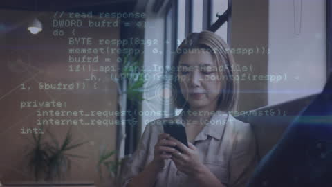 Asian Businesswoman Analyzing Data Overlaid with Code