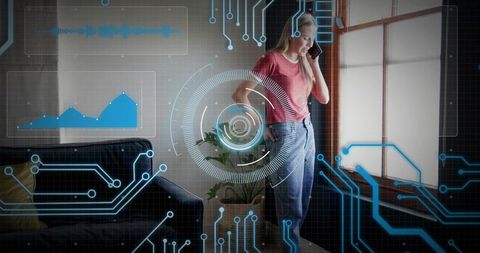 Young woman talking on smartphone by window with augmented reality interface overlays