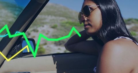 Woman relaxing in car on scenic road trip with neon effects