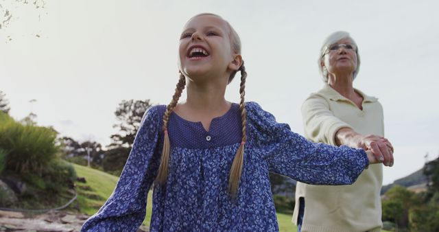 Grandmother and Granddaughter Holding Hands in Park - Download Free Stock Images Pikwizard.com