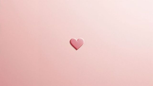 Minimal Glossy Pink Heart Sticker on Pale Pastel Pink Background with Negative Space