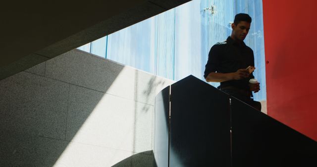 Young Professional Walking Down Stairs in Modern Office Building - Download Free Stock Images Pikwizard.com