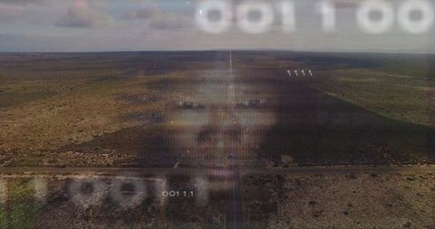 Futuristic Holographic Face Over Desert with Binary Code