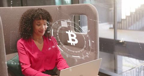 Businesswoman in co-working space with bitcoin digital interface