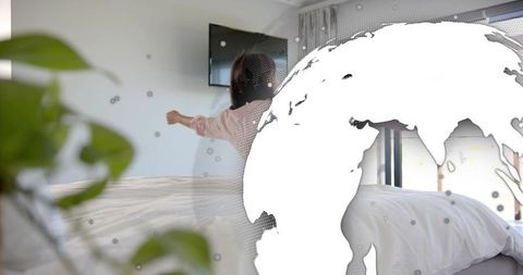 Woman stretching on bed in minimalist bedroom with global map overlay, plant, daylight