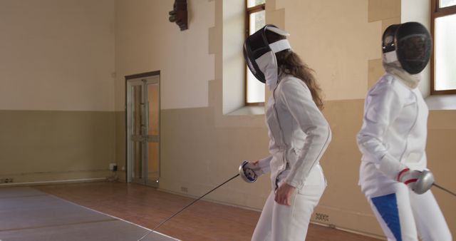 Female Fencers Preparing to Duel in Gymnasium - Download Free Stock Images Pikwizard.com