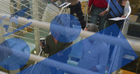 Team Discussion with Infographic Interface at Office Staircase