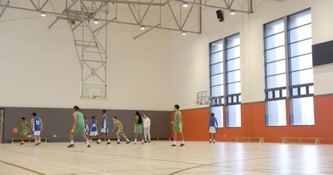 Intense Basketball Game in Modern Indoor Court with Team Dynamics