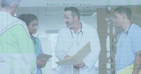 Medical Team Analyzing Charts with Modern Technology in Hospital Environment