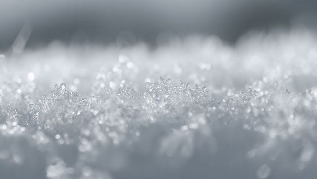 Glistening Snow and Ice Granules on Winter Ground