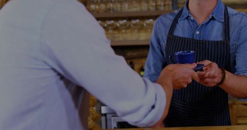 Hands Exchanging Coffee in Modern Cafe
