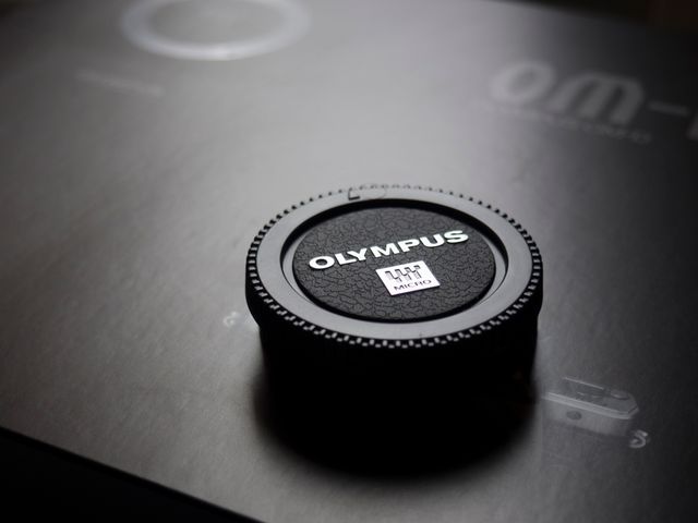 Olympus Camera Lens Cap Placed on Box - Download Free Stock Photos Pikwizard.com