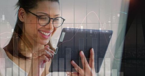 Businesswoman Analyzing Data on Tablet with Graphs Overlaid