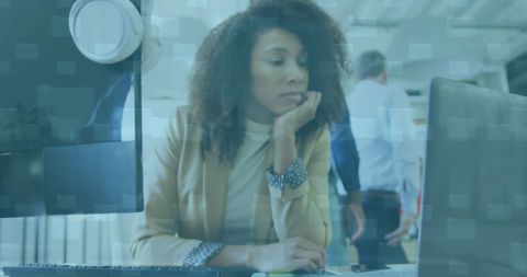 African American Businesswoman Analyzing Data on Laptop in Office