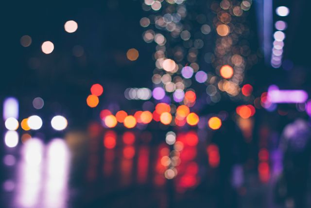 Depicts vibrant and colorful city streets at nighttime with a beautiful bokeh effect. Suitable for use in projects related to urban life, nightlife, cityscape backgrounds, or as abstract art for presentations and websites.